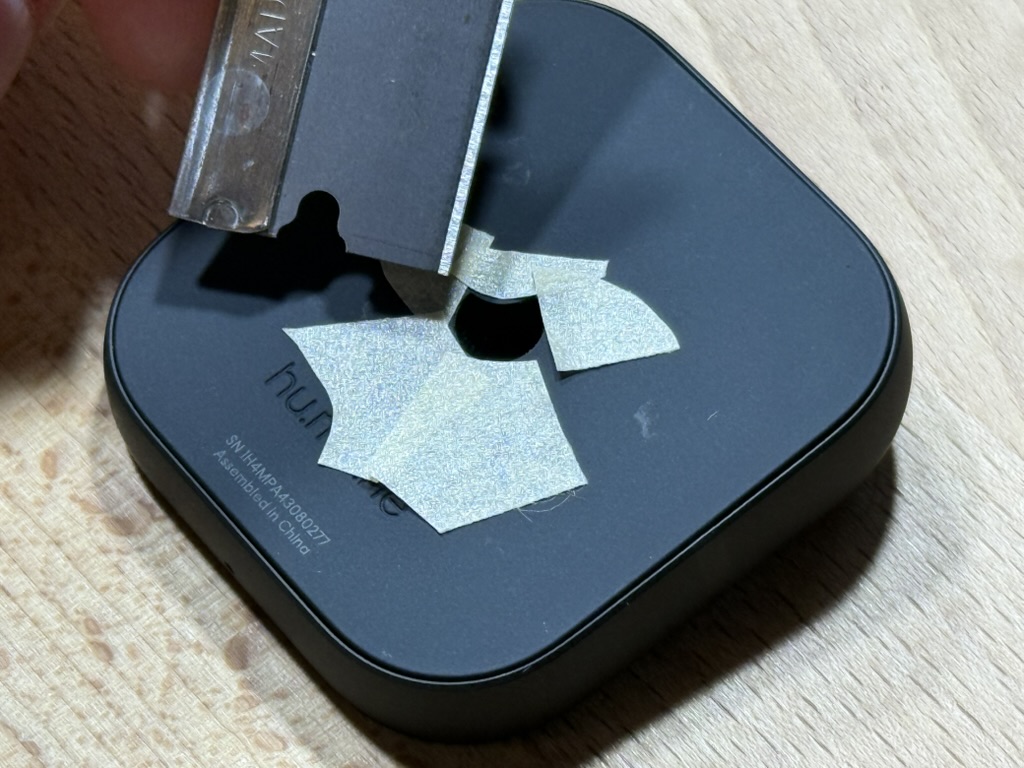 Using a razor blade to pry the moon sticker